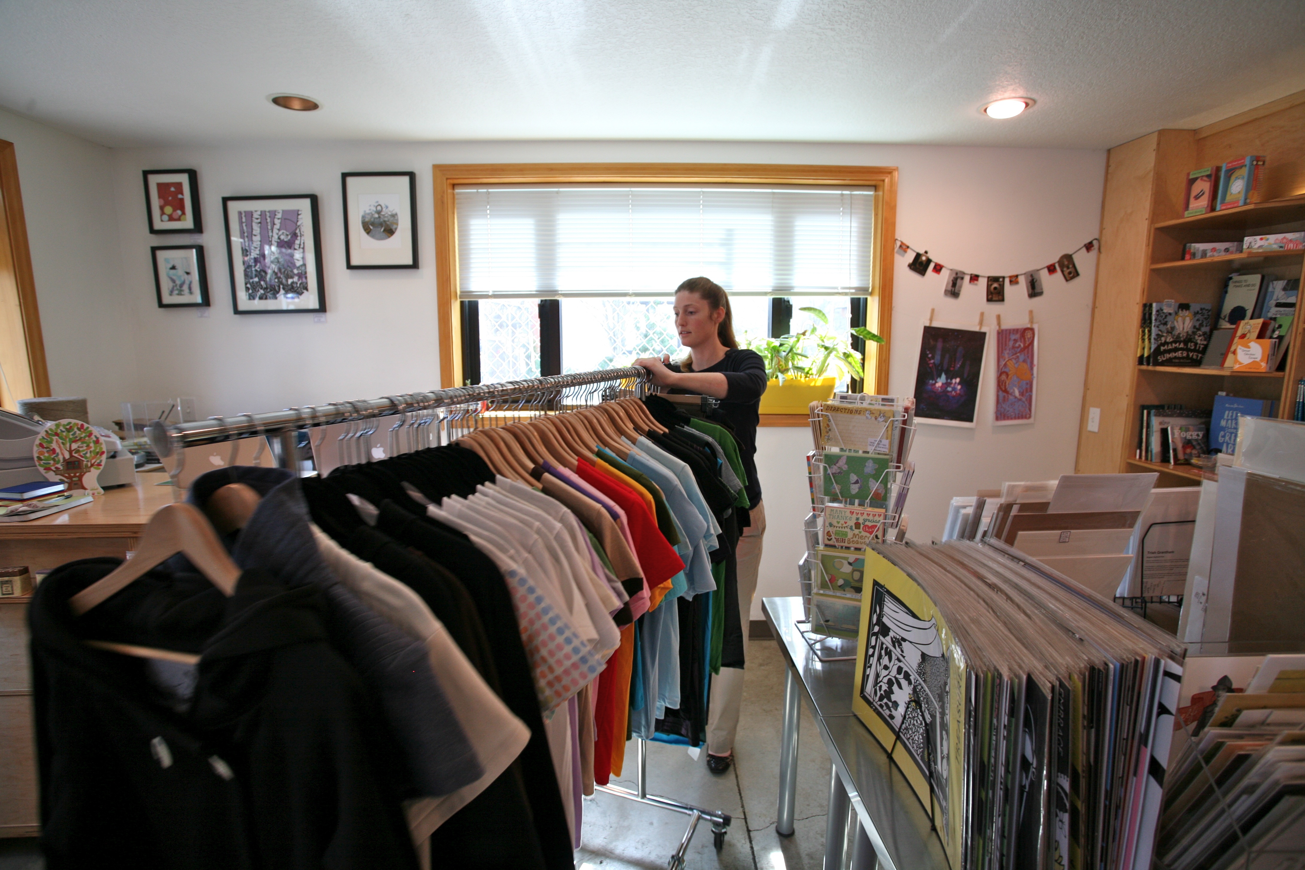 Moving the shirt racks out of the way.